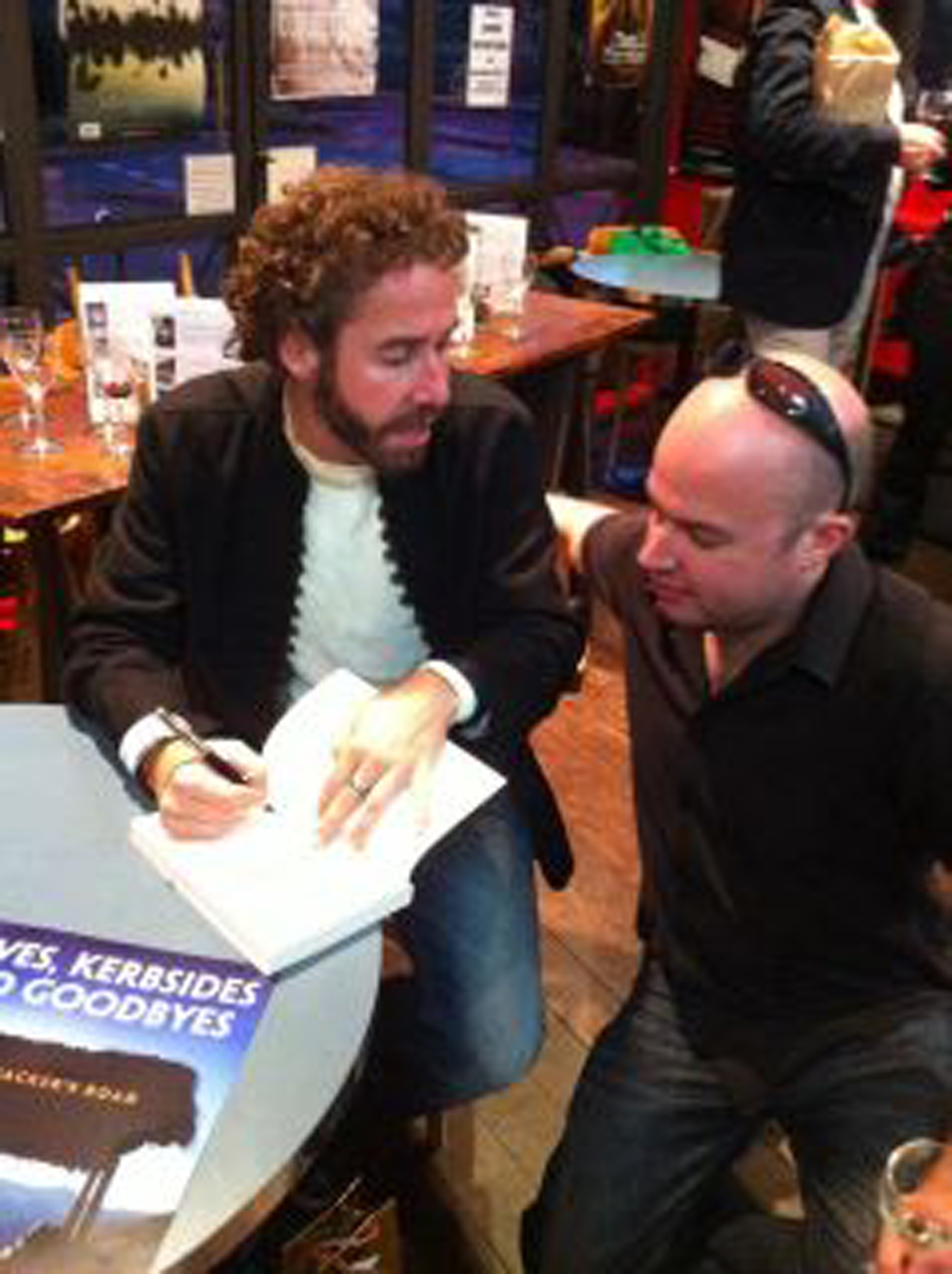 David signs a copy for his best friend Chris